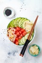 Hawaiian watermelon poke bowl with avocado, cucumber, mung bean sprouts and pickled ginger. Top view, overhead