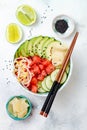 Hawaiian watermelon poke bowl with avocado, cucumber, mung bean sprouts and pickled ginger. Top view, overhead