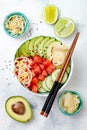 Hawaiian watermelon poke bowl with avocado, cucumber, mung bean sprouts and pickled ginger. Top view, overhead