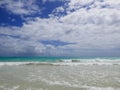 Hawaiin beach with turquoise water and blue, cloudy sky