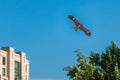 Hawk kite flying in blue sky over city