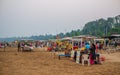 Hawkers selling street snacks and fast food on the Indian beach. Families spend leisure time on beaches