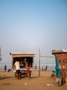 Hawkers selling street snacks and fast food on the Indian beach. Families spend leisure time on beaches