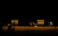 Hawkers selling street snacks and fast food on the Indian beach at night. Families spend leisure time on beaches