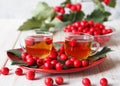 The hawthorn harvesting season for future use. Alternative medicine. The benefits of herbal hawthorn tea.Two cups of herbal tea on
