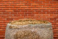 Hay bale against red brick wall on the ranch Royalty Free Stock Photo