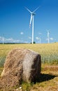 Hay bale with wind turbines Royalty Free Stock Photo