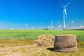 Hay bale with wind turbines Royalty Free Stock Photo