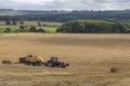 Hay Baler working in a field - United Kingdom Royalty Free Stock Photo