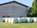 Hay bales coating with plastic film for protection from the over Royalty Free Stock Photo