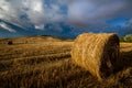 Hay bales dot field in Tuscany before storm hits
