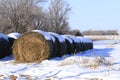 Hay Bales in a farm field with snow in the Winter time Royalty Free Stock Photo