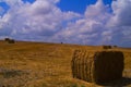 Hay bales in the field below white clouds, Menashe mountains, north Israel Royalty Free Stock Photo