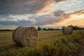 Hay bales in the field and evening clouds Royalty Free Stock Photo