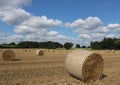 Hay bales in a field with trees and meadows in Yorkshire UK