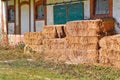 Hay bales in front of old abandoned farm building Royalty Free Stock Photo