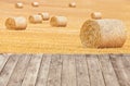 Hay bales on harvested field with wooden boards