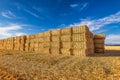 Hay bales on harvested wheat field in Provence against dramatic blue sky in summer Royalty Free Stock Photo