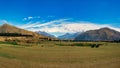 Hay bales sitting on agricultural farm fields beneath the Southern Alps Royalty Free Stock Photo