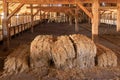 Hay bales stacked in old wooden barn on historic cattle ranch Royalty Free Stock Photo