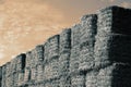 Hay bales stacked on top of each other for animal feed set against sky. Royalty Free Stock Photo