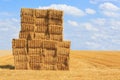 Hay bales stacked up on an empty harvested field Royalty Free Stock Photo