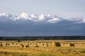 Hay in bales at sunset before a storm