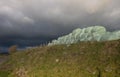 Hay bales under stormy skies