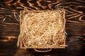 Hay in box on brown wooden pallet with decorative hay inside on a rustic table. top view, space for text Royalty Free Stock Photo