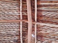 View from below of the palm leaf roof. Close up of rustic roof made of wood, straw and dry leaves. Architecture and tropical Royalty Free Stock Photo