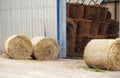 Hay stack rolls at farm, metal storage barn in background Royalty Free Stock Photo