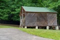 hay storage barn with green trees in the background Royalty Free Stock Photo