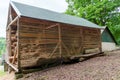 hay storage barn with green trees in the background Royalty Free Stock Photo