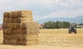 Hay tractor stacking hay bales on a big pile Royalty Free Stock Photo