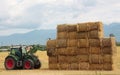 Hay tractor stacking hay bales on a big pile Royalty Free Stock Photo