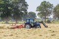 Hay turning to dry grass in the sun on the field in the Netherlands Royalty Free Stock Photo