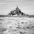 Hay windrows drying in the sun in front of the Mont Saint-Michel tidal island in Normandy, France