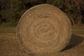 A Haybale Spiral in the Midwest setting sun on it.