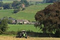 Haying Belgian farmer in meadow, Belgium