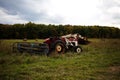 Haymaker tractor working on a field during daytime Royalty Free Stock Photo