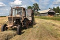 Haymaking time, Russian farm tractor with round baler harvests h