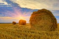 Hayrolls on sunset background Royalty Free Stock Photo