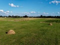 Haystack on a farm field on a sunny summer day, view from the top.