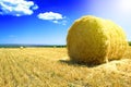 Haystack in the field after harvesting wheat in the high season with a hot summer