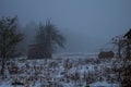 Haystack on the field during the winter and fog. Winter sadness.