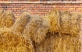 Haystack in front of an old brick building