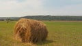 Haystack on a green field. Hay Bales On Field Against Sky. Haystacks in the field in summertime. Big hay bay rolls in a green Royalty Free Stock Photo