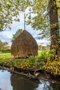 Haystack on a meadow close to the water Royalty Free Stock Photo