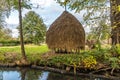 Haystack on a meadow close to the water Royalty Free Stock Photo