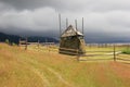 Haystack on mountain meadow with stormy sky Royalty Free Stock Photo